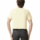 Person wearing a light yellow t-shirt and black jeans, shown from the back, against white background.