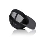Black mesh-back baseball cap lying upside down on a white reflective surface.