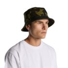 Man wearing a camouflage bucket hat and white t-shirt against a plain background.