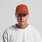 Man in a white shirt and orange cap looking forward with a neutral expression.