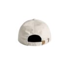 Beige baseball cap viewed from the back, showing an adjustable strap and metal clasp.
