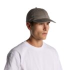 Man wearing a gray baseball cap and white t-shirt, facing to the right.