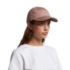 Woman in a pink baseball cap and white t-shirt against a plain white background.