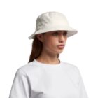 A woman wearing a white bucket hat and shirt-good for gifting teens