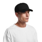 Person in a white shirt and black baseball cap looking to the side against a white background.