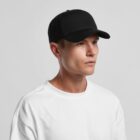 A person wearing a black baseball cap and a plain white shirt against a light background.