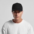Man wearing a black baseball cap and white T-shirt against a plain light background.