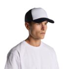 Man in a white t-shirt and black-and-white trucker hat on a plain white background.