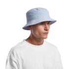 Man wearing a light blue bucket hat and a white shirt against a plain background.