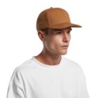 Man in a brown baseball cap and white shirt looking to the side against a white background.