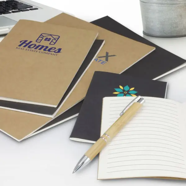 picture of various notebooks in a desk with a pen