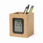 A cork pen holder with an electronic clock and two pens inside.