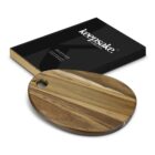 Wooden oval cutting board with a hole, next to a black Keepsake Collection box.