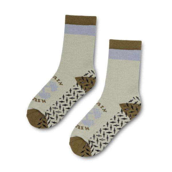 A pair of patterned beige socks with brown toes and heels and black geometric designs.