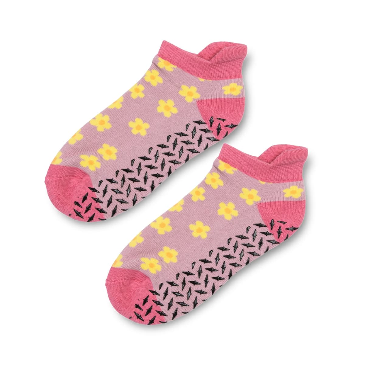 Pink ankle socks with yellow flower pattern and black grip dots on the soles.