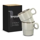Three stacked white coffee cups next to a black keepsake collection box.