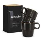 Two stacked black coffee cups beside a black Keepsake Collection box.