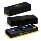 A blue Cross pen in a black and yellow gift box, with the box lid shown beside it.