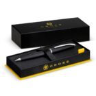 A black Cross pen in an open black and yellow Cross gift box.