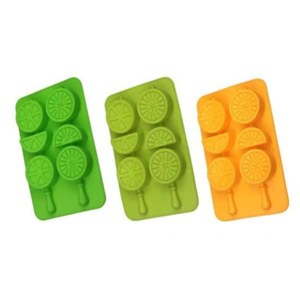 Three colorful silicone trays with citrus slice and wedge shapes, in green, yellow, and orange.