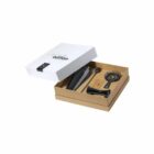 Open box with a black hair straightener, a comb, and a heat-resistant mat inside.