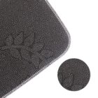 Close-up of a black textured fabric with white stitching and small white dotted patterns.