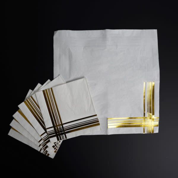 White napkins with gold foil stripes on a black background.