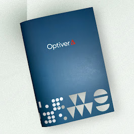 Blue Optiver folder with geometric shapes—ideal alongside notebooks for business needs.