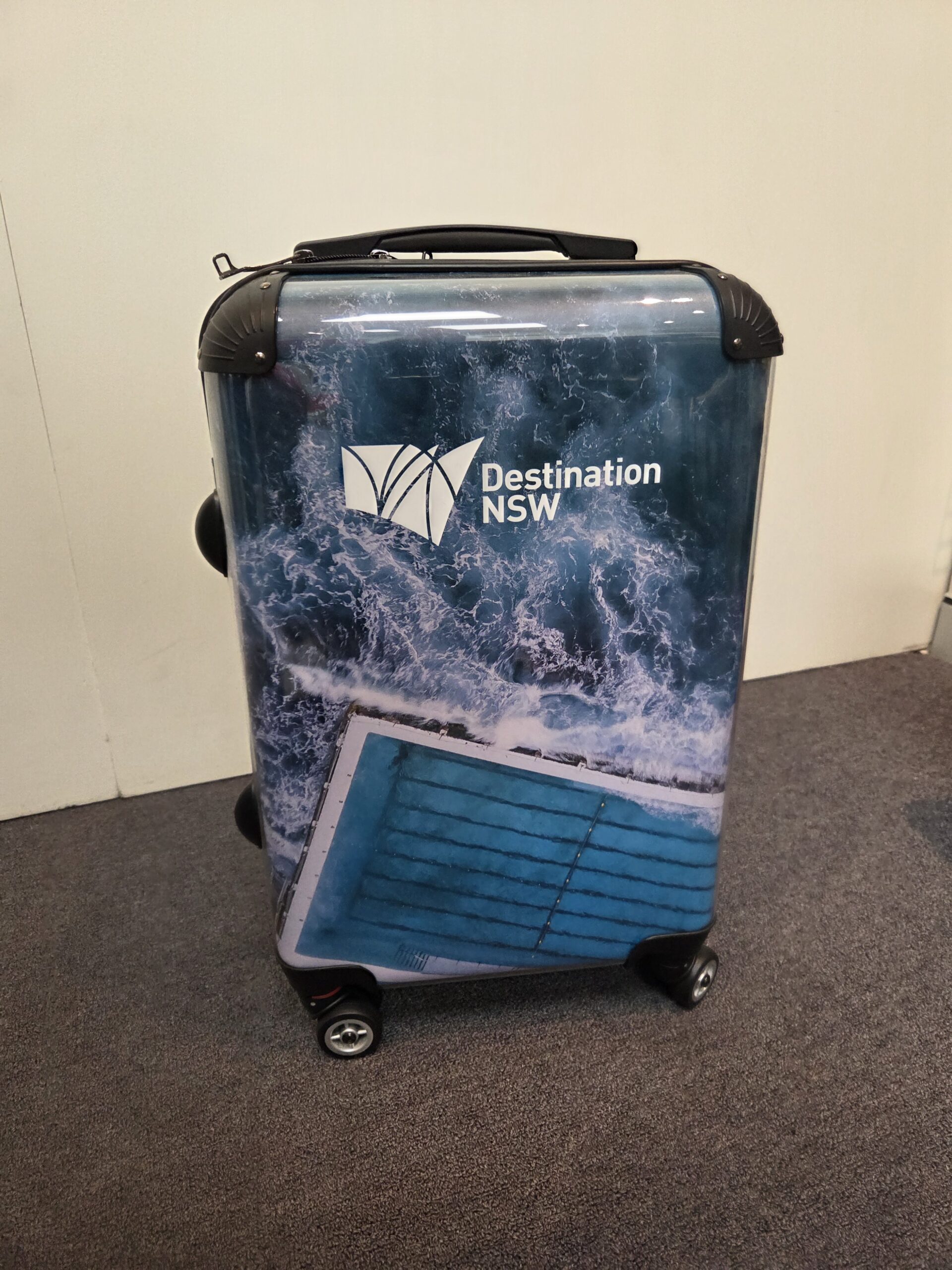 Custom printed luggage case with Destination NSW logo branded onto it