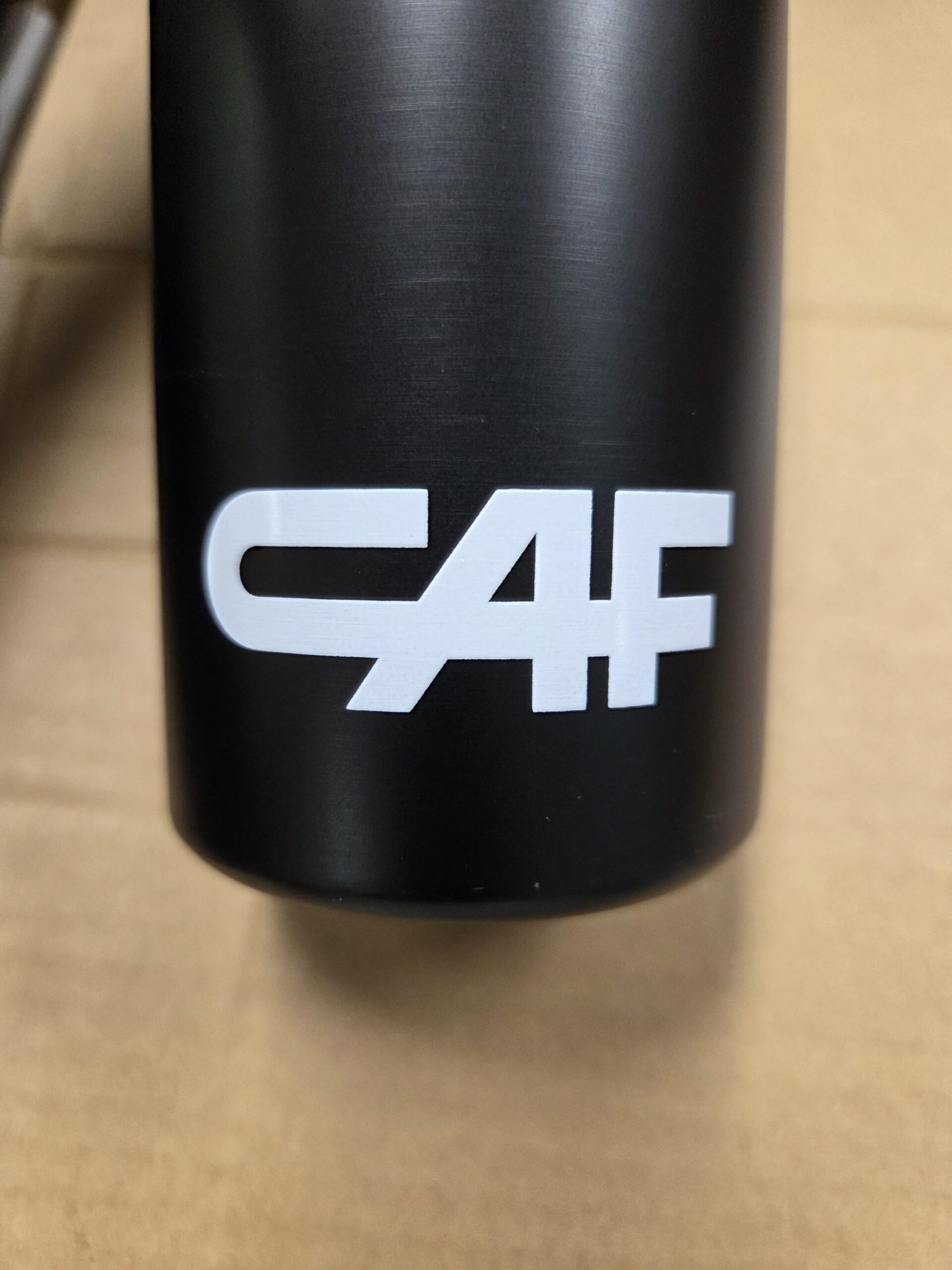 a metal bottle with CAF white print design
