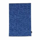 A rectangular blue towel with a subtle textured pattern and a small black tag on the edge.