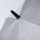 Close-up of a grey fabric umbrella with a black tip against a light background.