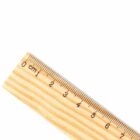 A wooden ruler showing centimeter marks from 0 to 6 on a white background.