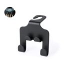 Black car seat headrest hook for hanging bags, shown with an example in use.