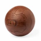 A vintage brown leather soccer ball with visible stitching on a white background.