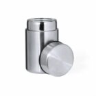 Stainless steel container with an open lid placed beside it on a white background.