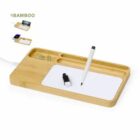 Bamboo desk organizer with slots, paper, pen, USB drive, and paper clips on top.