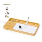 Bamboo desk organizer with pen, USB drive, paper clips, and wireless charging pad.