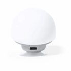 Round white device with a micro USB port at the base, seen from the back.
