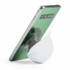 Smartphone propped up by a white, teardrop-shaped phone stand with a suction cup.