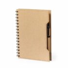 A spiral-bound brown notebook with a pen attached to the cover.