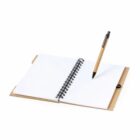 Open spiral notebook with blank pages and a pen resting on top.
