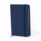 A closed navy blue notebook with an elastic band and ribbon bookmark.