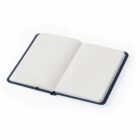 An open blank notebook with a dark cover lying on a white surface.