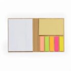 Open notebook with white paper, yellow sticky notes, and colorful page tabs on the right.