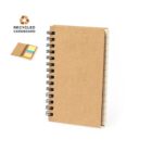 Brown spiral notebook made of recycled cardboard with sticky notes, opened slightly.