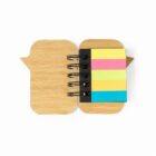 Small open notebook with colored sticky notes in yellow, pink, green, and orange on the right.