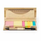Open bamboo stationery box with sticky notes, page markers, pen, and a ruler inside.