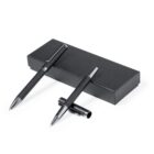 Two black pens with silver accents beside and on top of a black rectangular box.