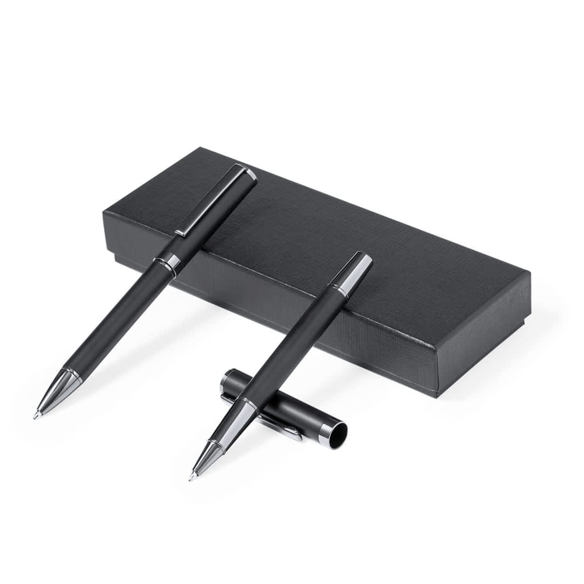 Two black pens with silver accents beside and on top of a black rectangular box.
